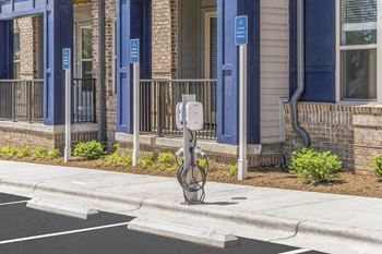 a parking meter on a sidewalk in front of a building at Preston Ridge, North Carolina